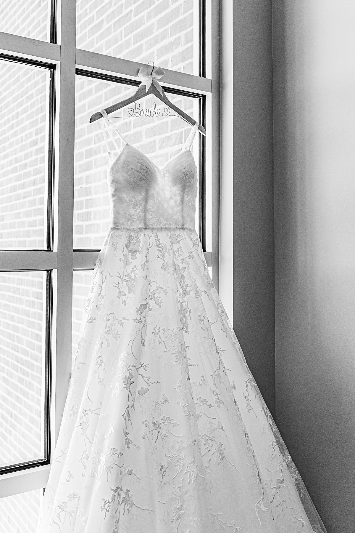 wedding-dress-hanging-from-windowframe