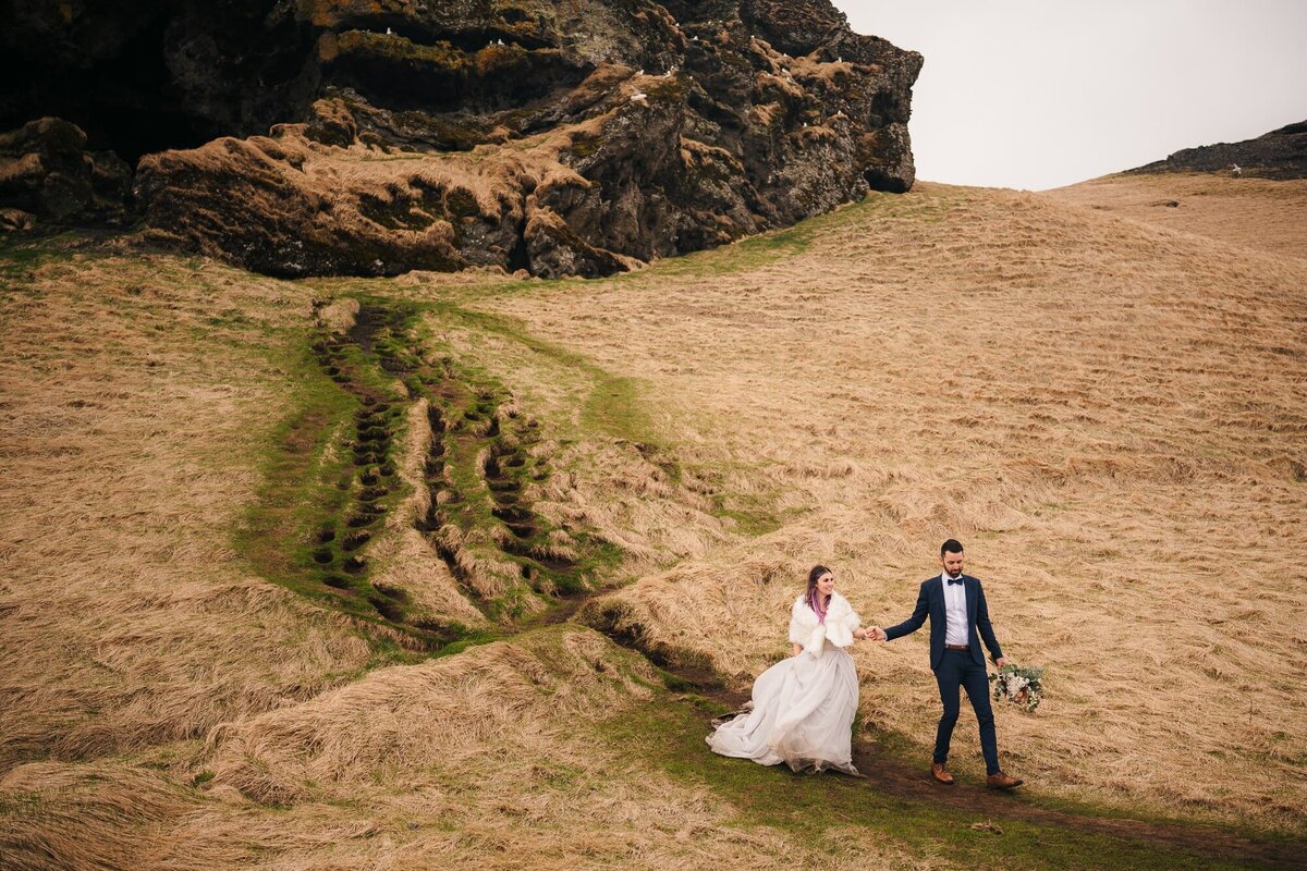 Hand in hand, this adventurous couple walks through the mystical caves of Iceland during their elopement, creating memories as unique as the journey they've chosen.