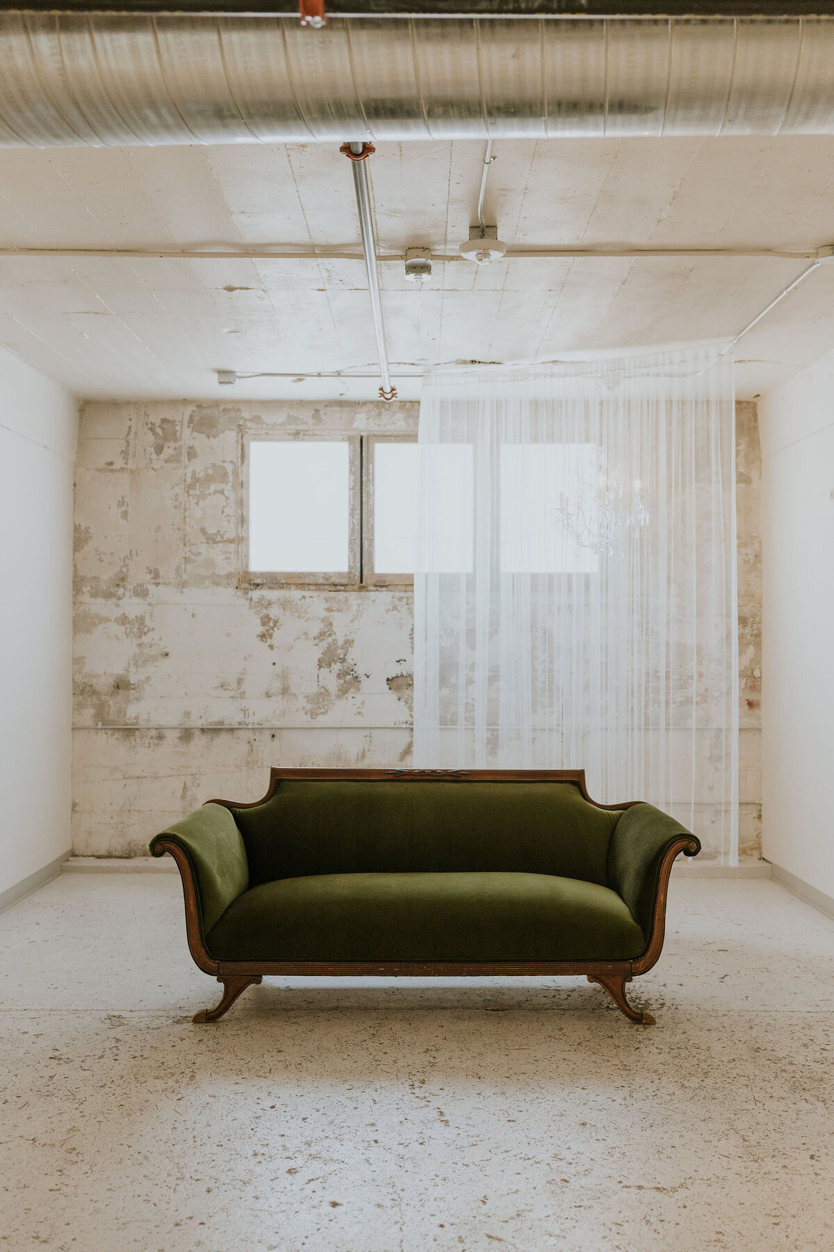Vintage green sofa at the st vrain wedding venue in Longmont CO.