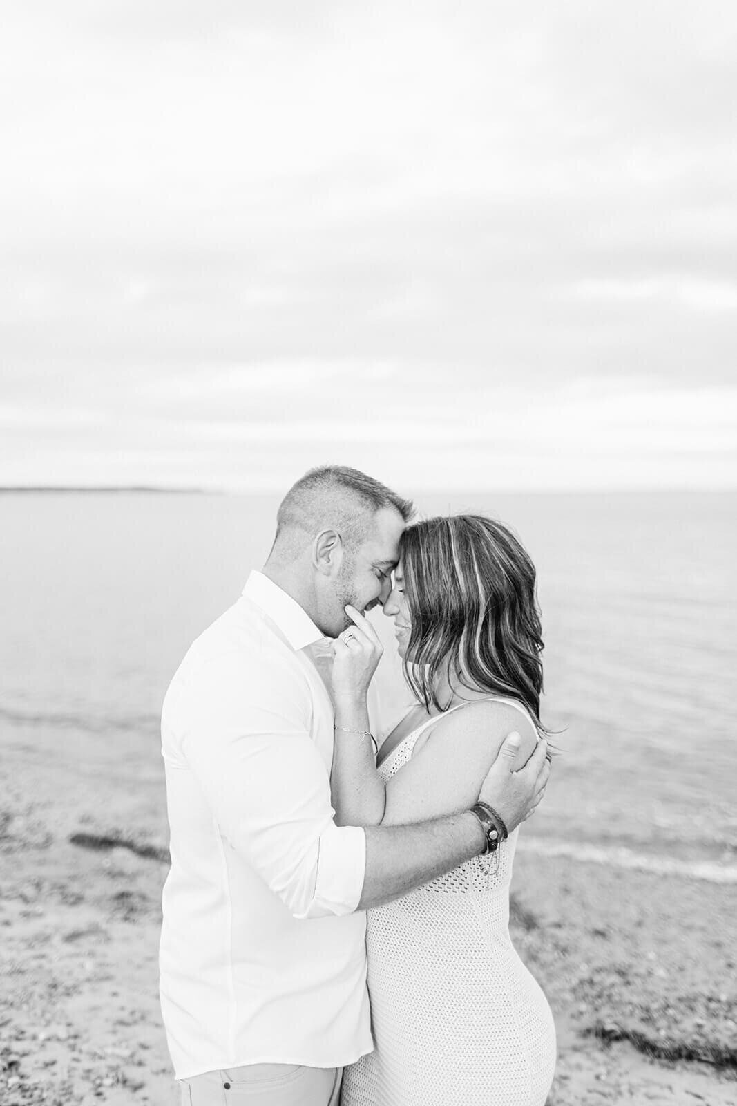 man-and-woman-share-kiss-on-beach-Canada