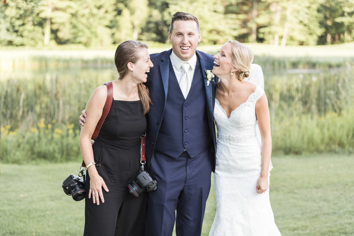 Photographer laughing with couple