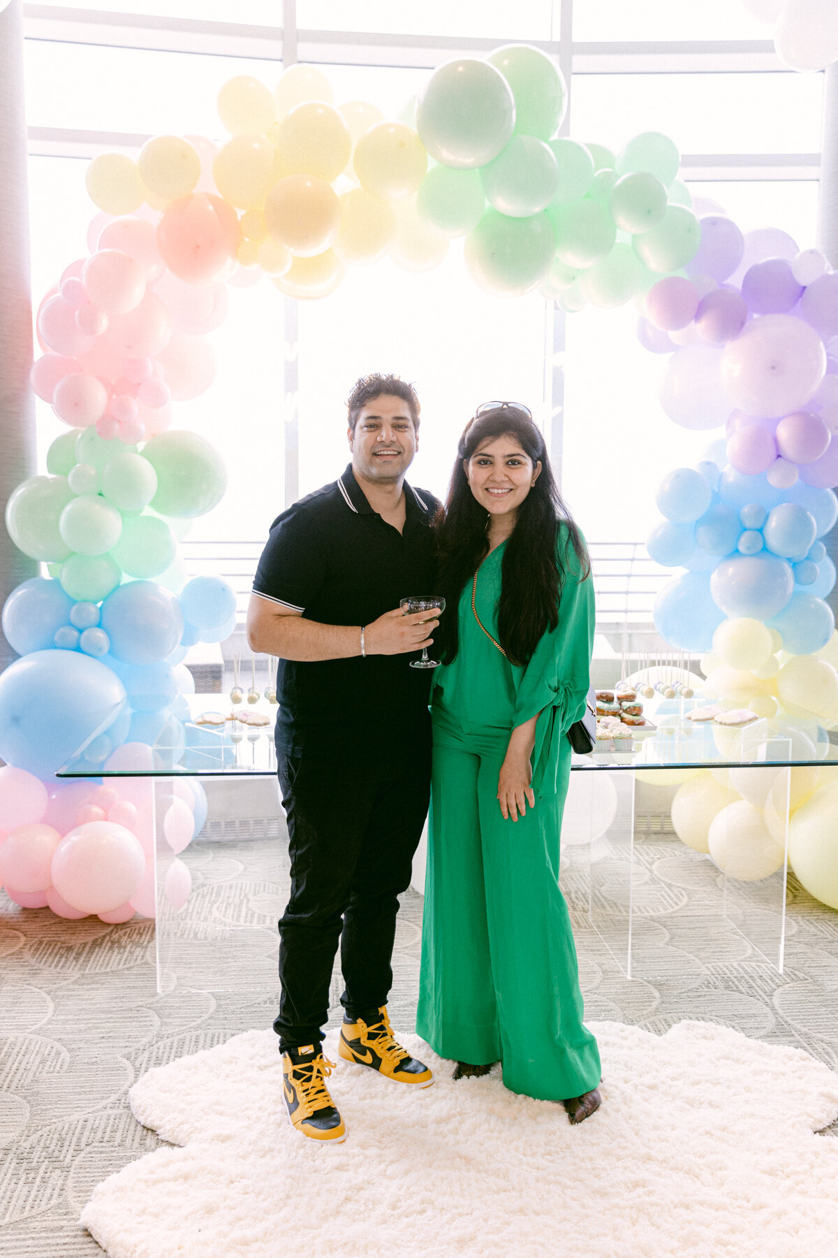 Guests Posing with Balloon Arch