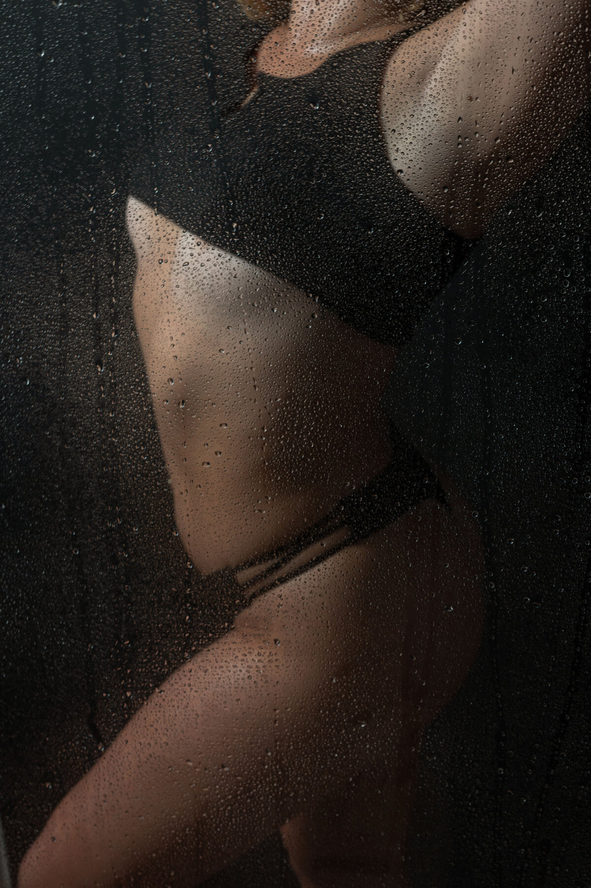 A boudoir shower scene of a woman's body.