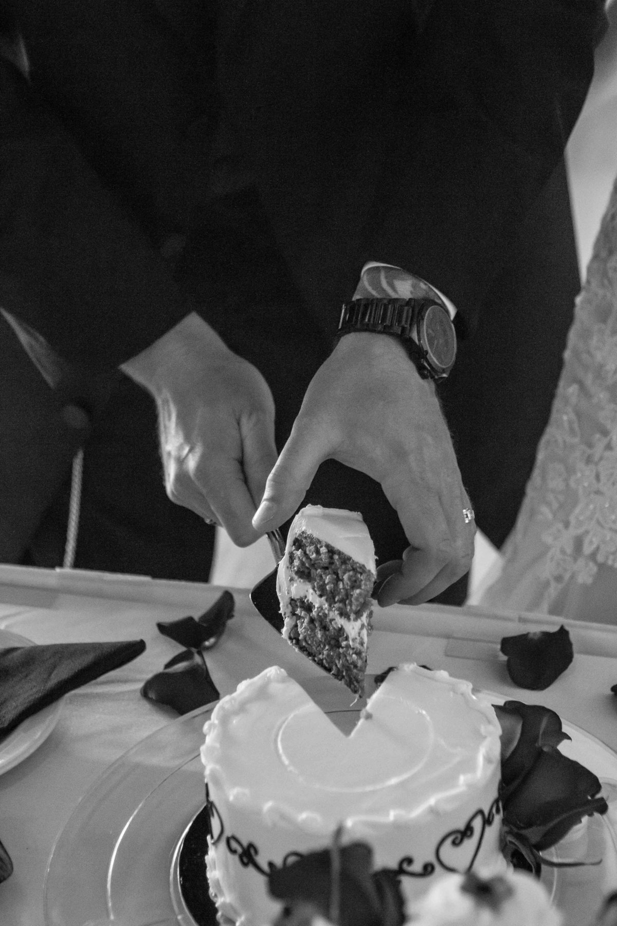 cake slice in grooms hand