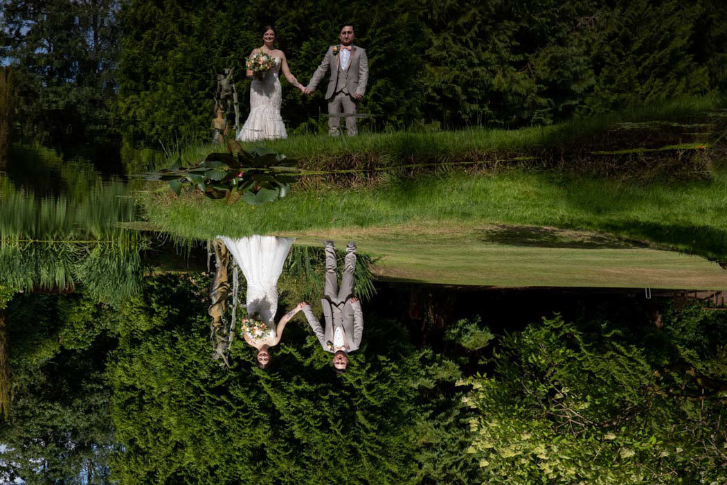 Bride and Groom reflected in pond at Bovey Castle
