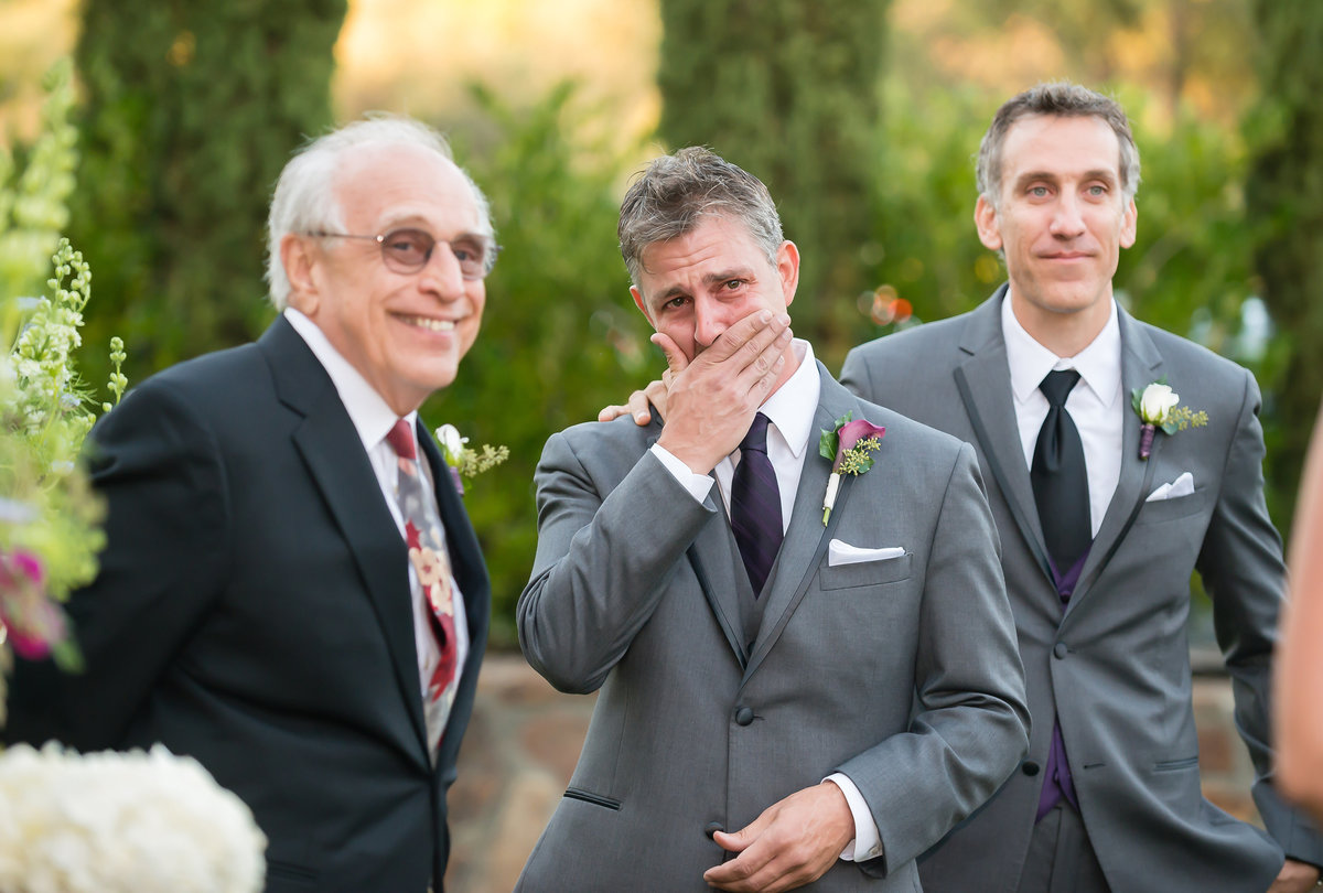 Groom cries at a vineyard wedding
