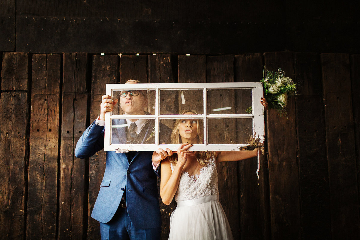 bride and groom with their faces squished against a window