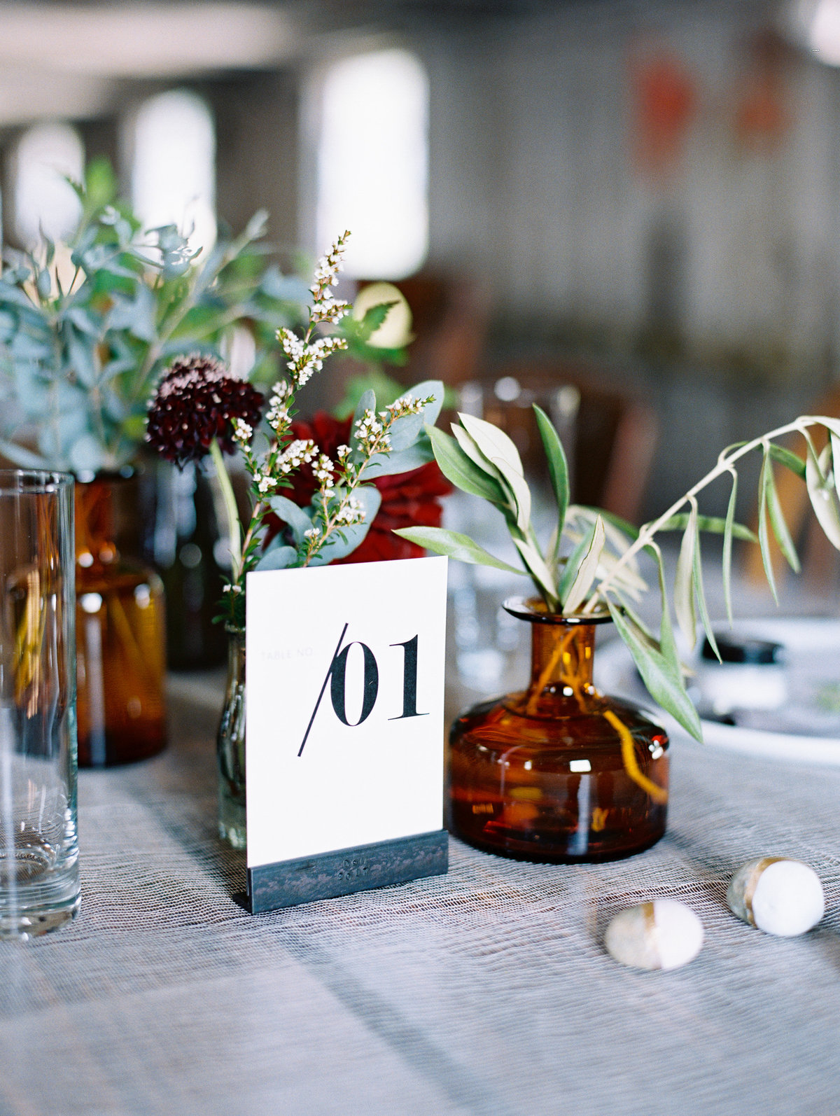 Industrial table number modern wedding amber bottles © Bonnie Sen Photography