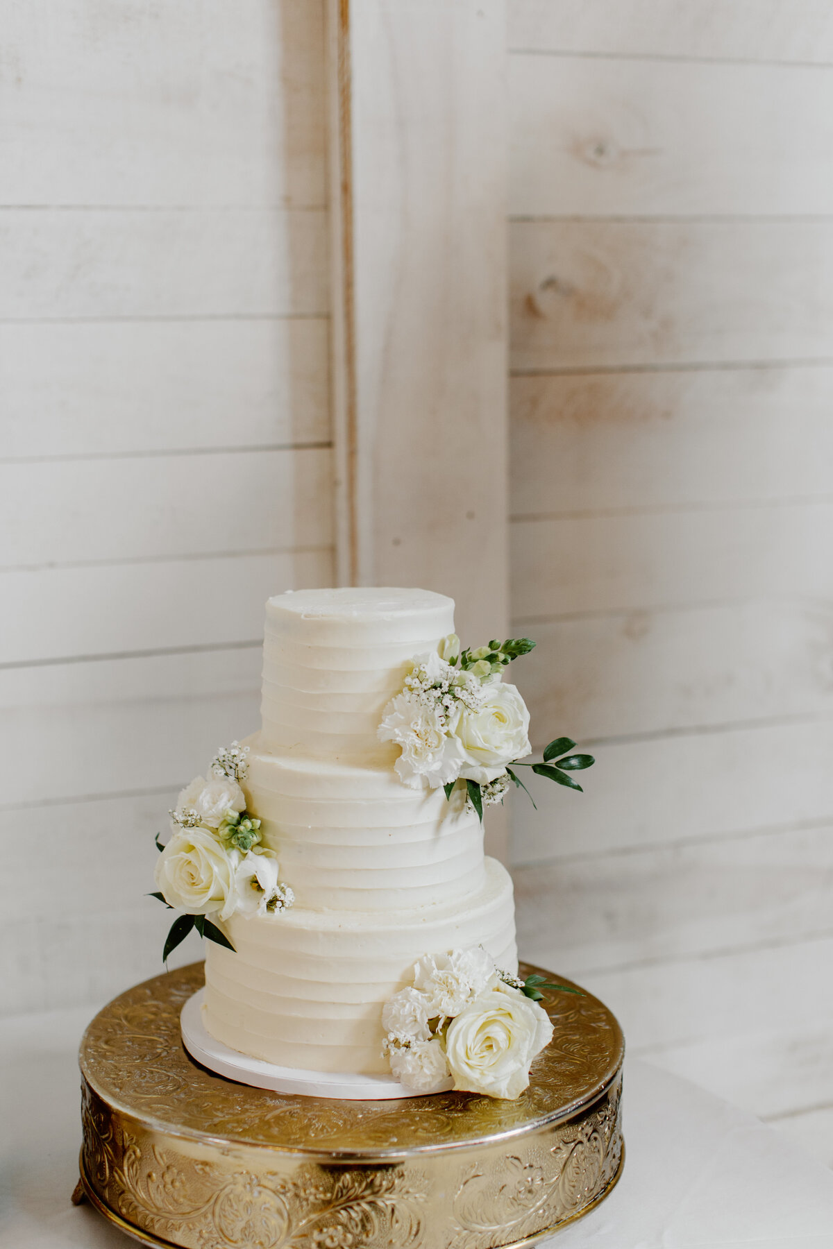 3 tier classic wedding cake with fresh roses
