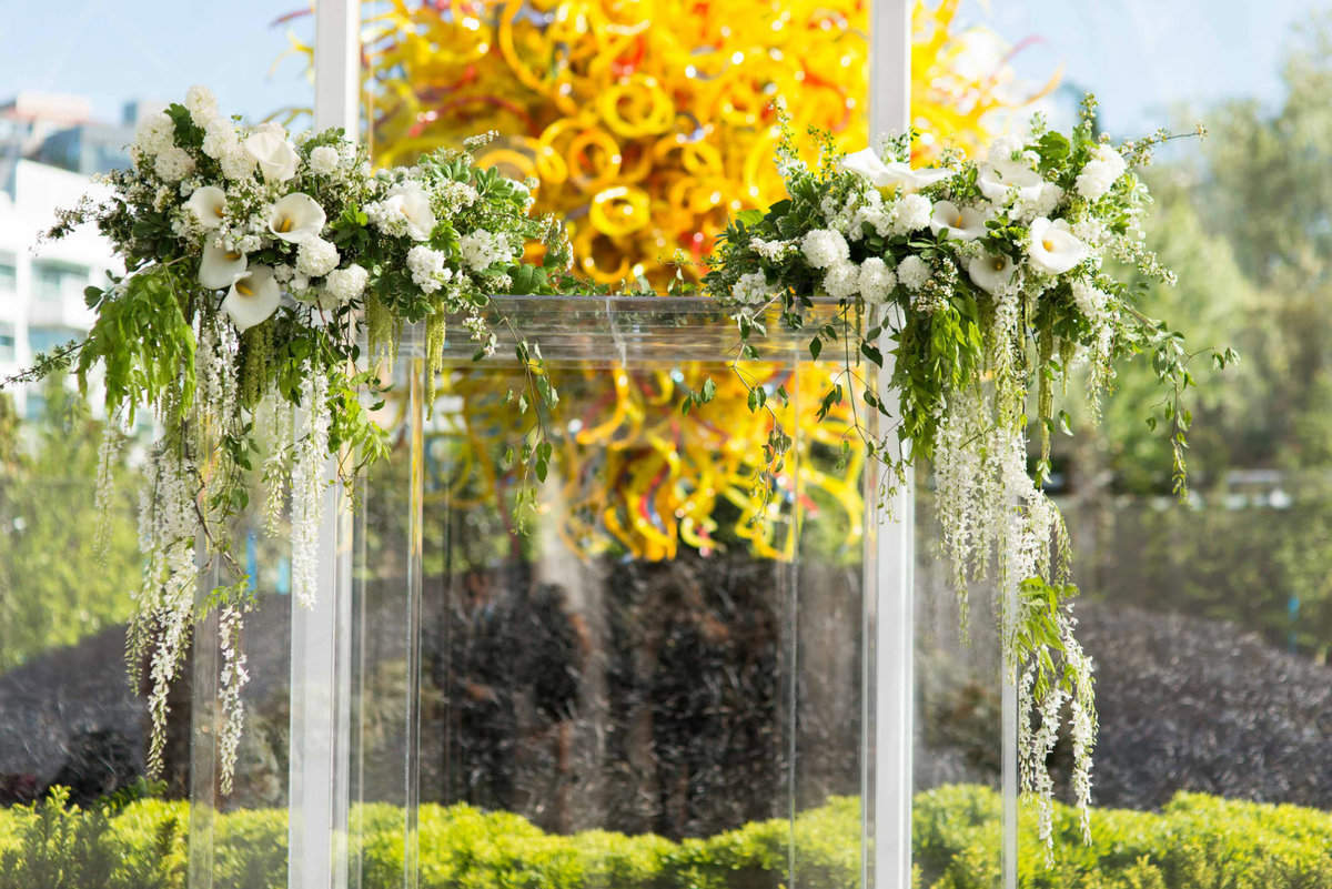 Stunning clear lucite huppah with white spirea and calla lilies on top.