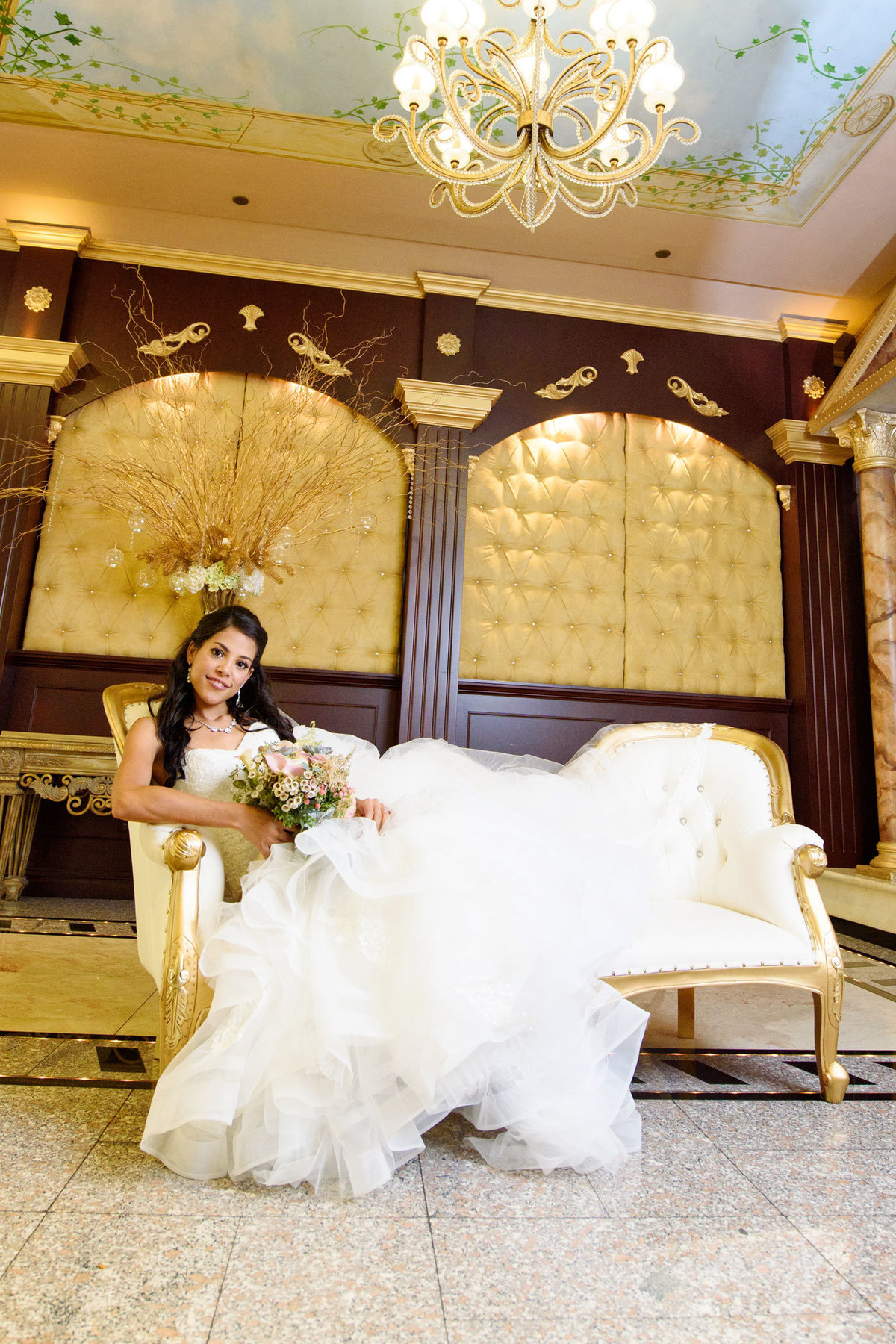 stunning bride sitting on the couch at Sand Castle