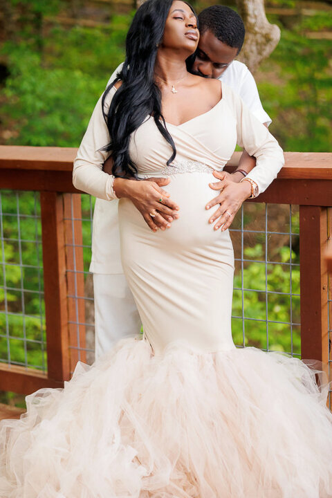 a couple embracing during their maternity photoshoot at piedmont park atlanta georgia