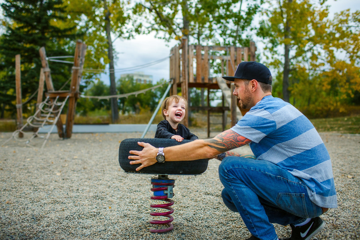 Dad and son at park laughing