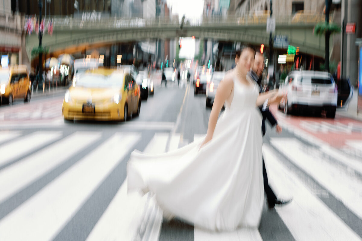 blurred imagery of wedding couple walking across the street in NYC