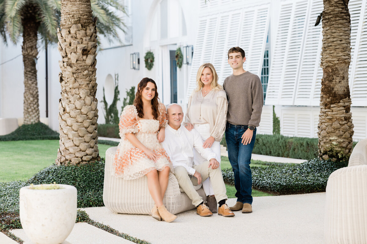 A family sitting and standing in a small patio area