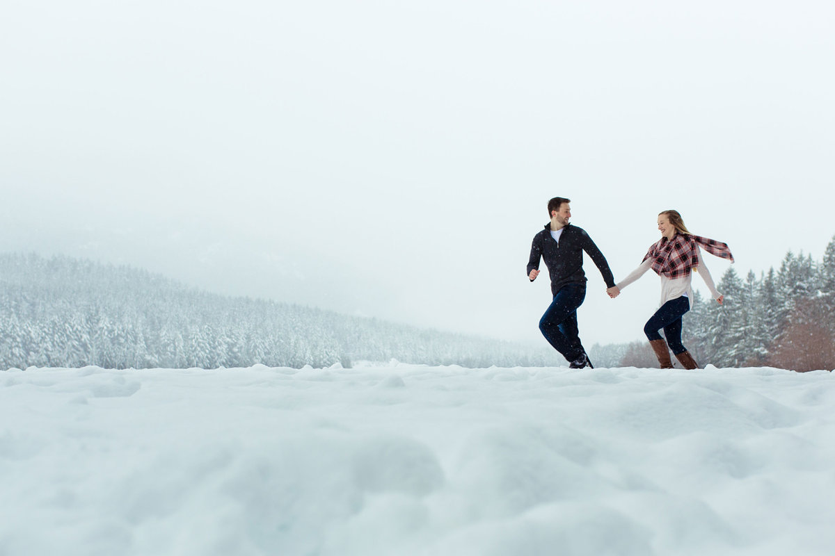 Photo of couple running in the snow