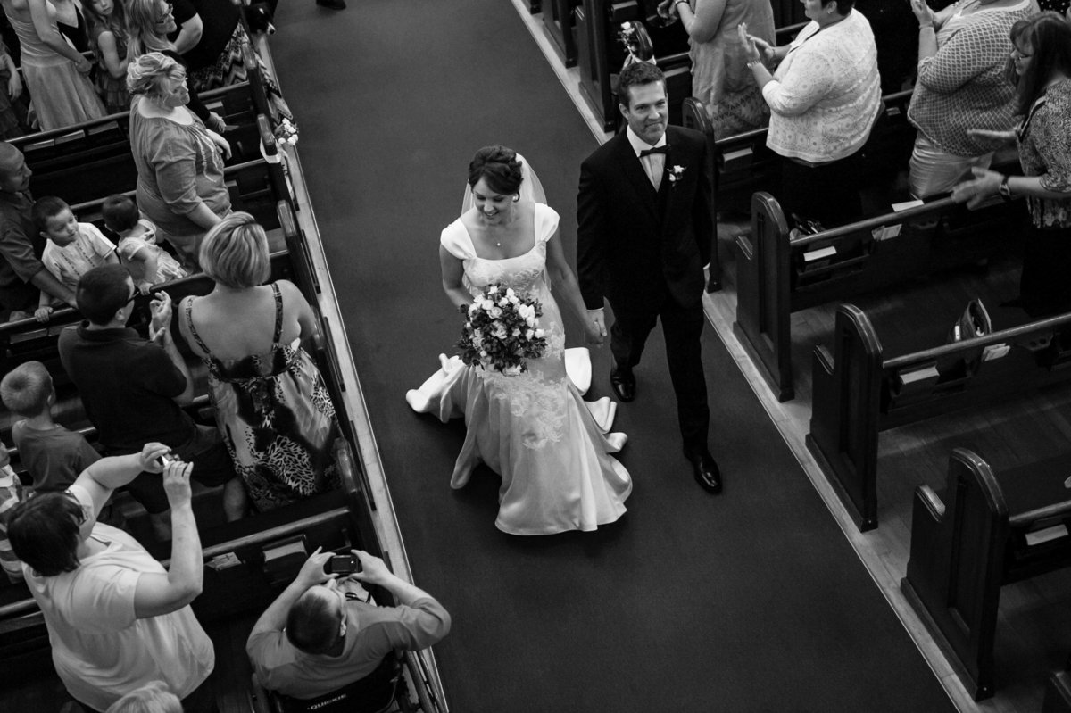 aerial shot from balcony couple in aisle
