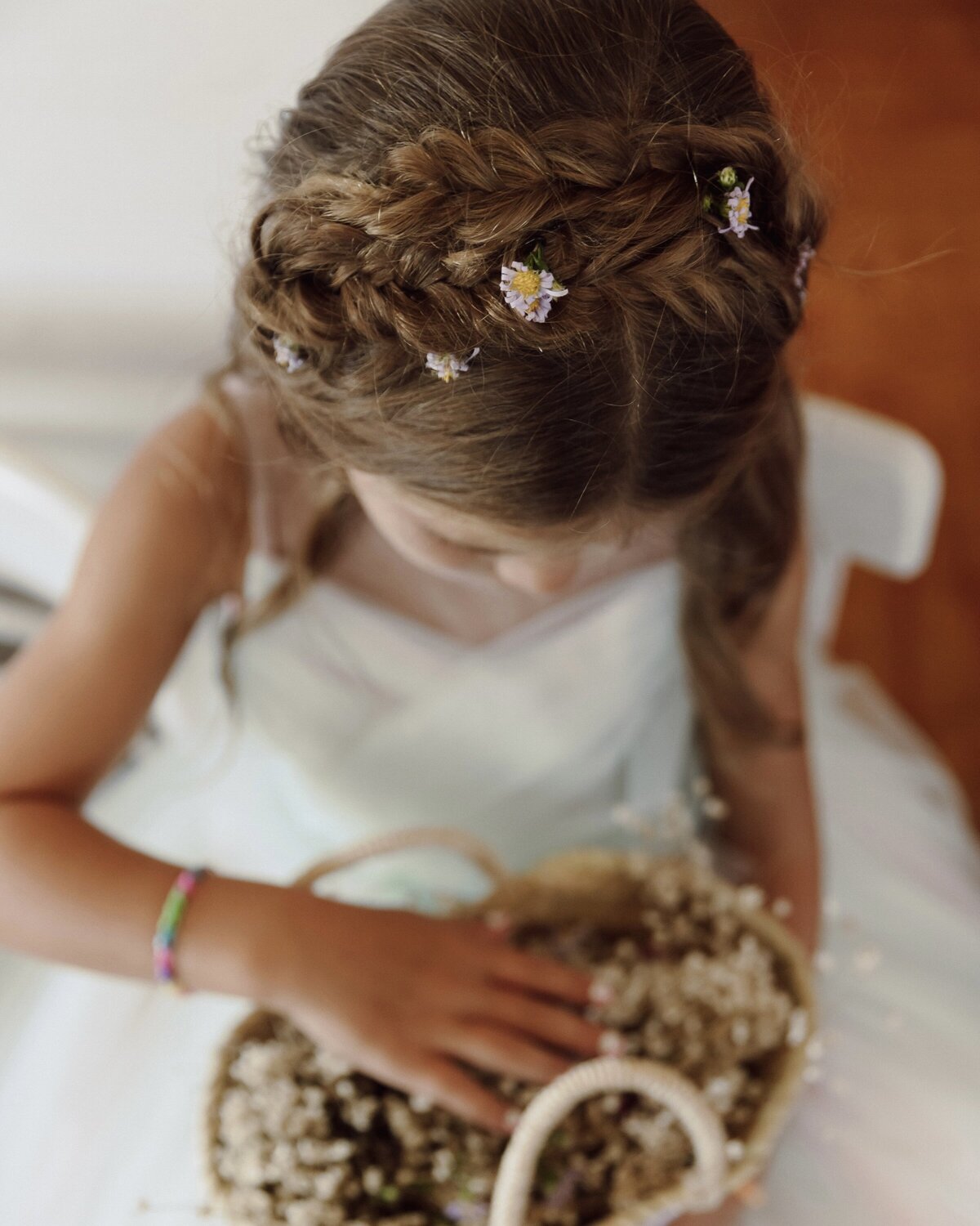Crows nest wedding flower girl hair with braids and flowers