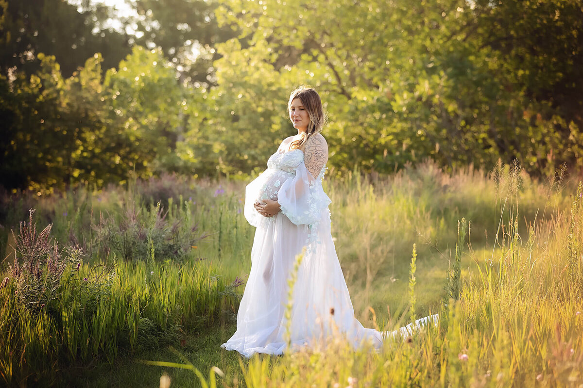 Outdoor maternity session in a field of wildflowers.
