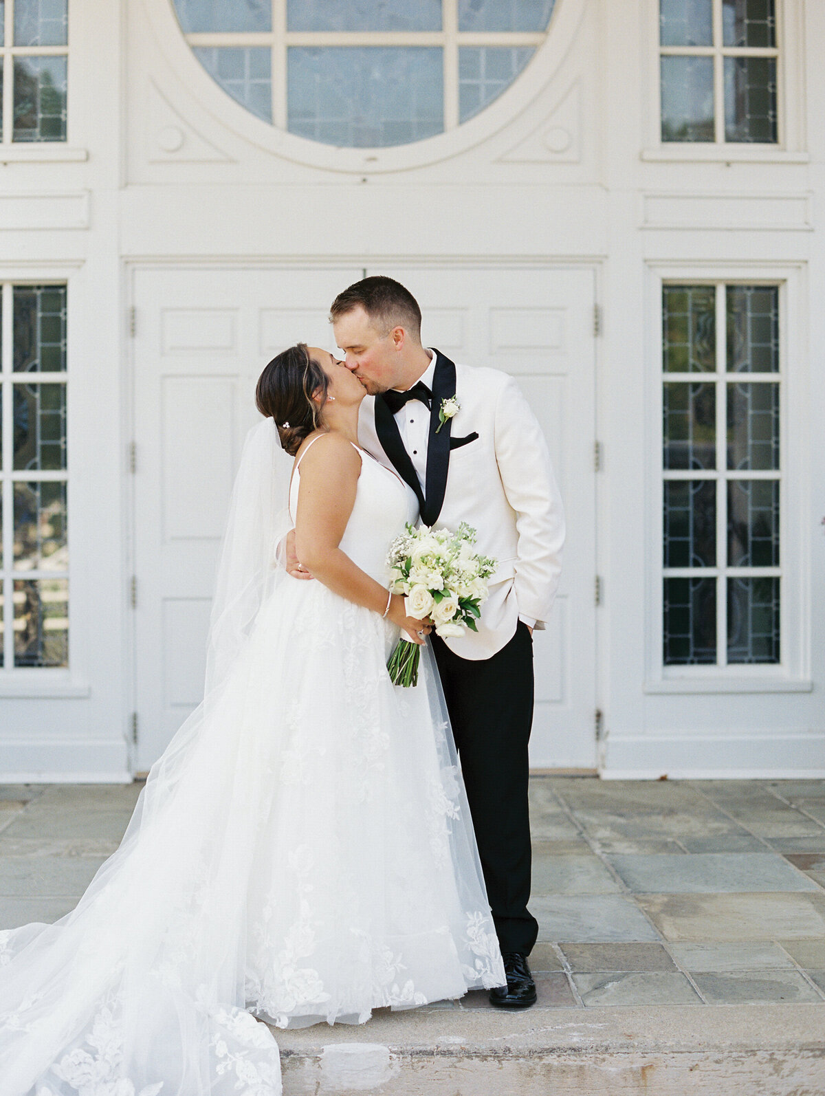 bride-and-groom-kissing-on-church-steps