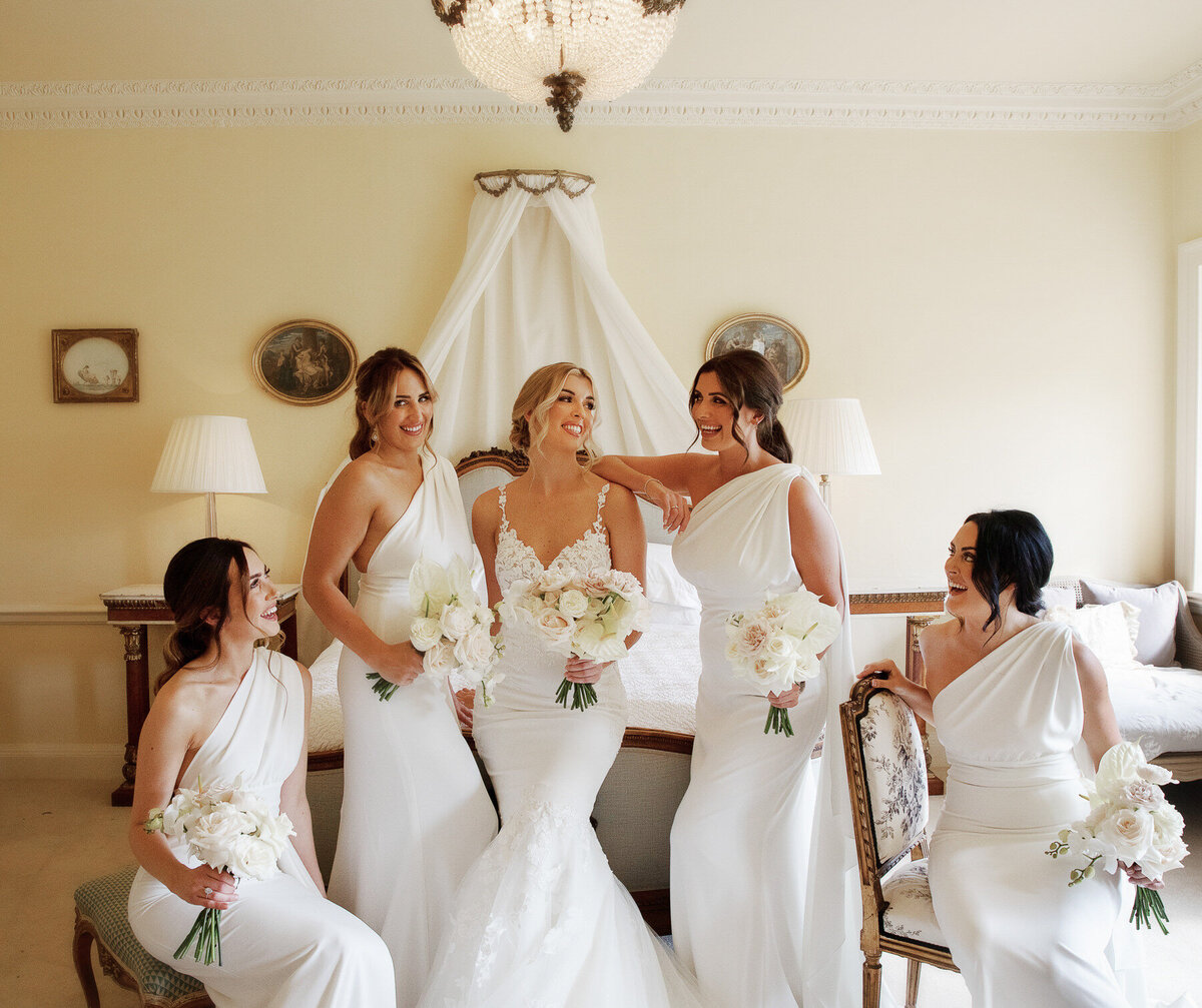 Bridesmaids posing with bride in suite at came House
