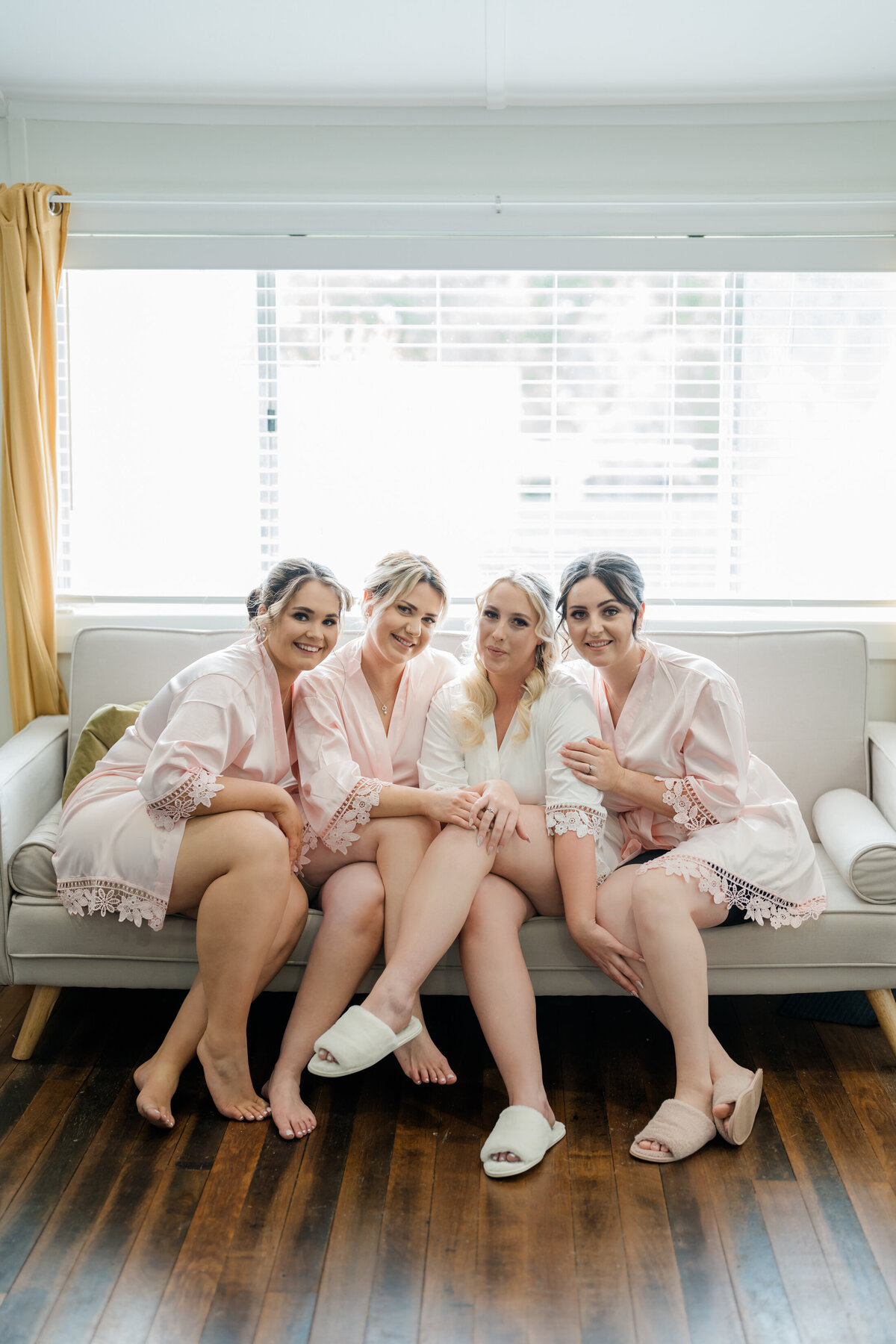 Bridemaids sitting with a bride on her wedding day