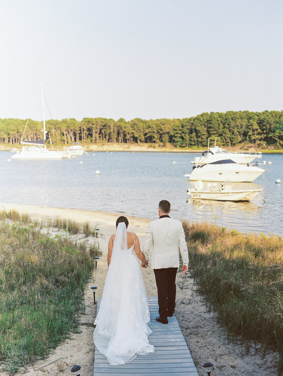 bride-and-groom-walking-toward-water