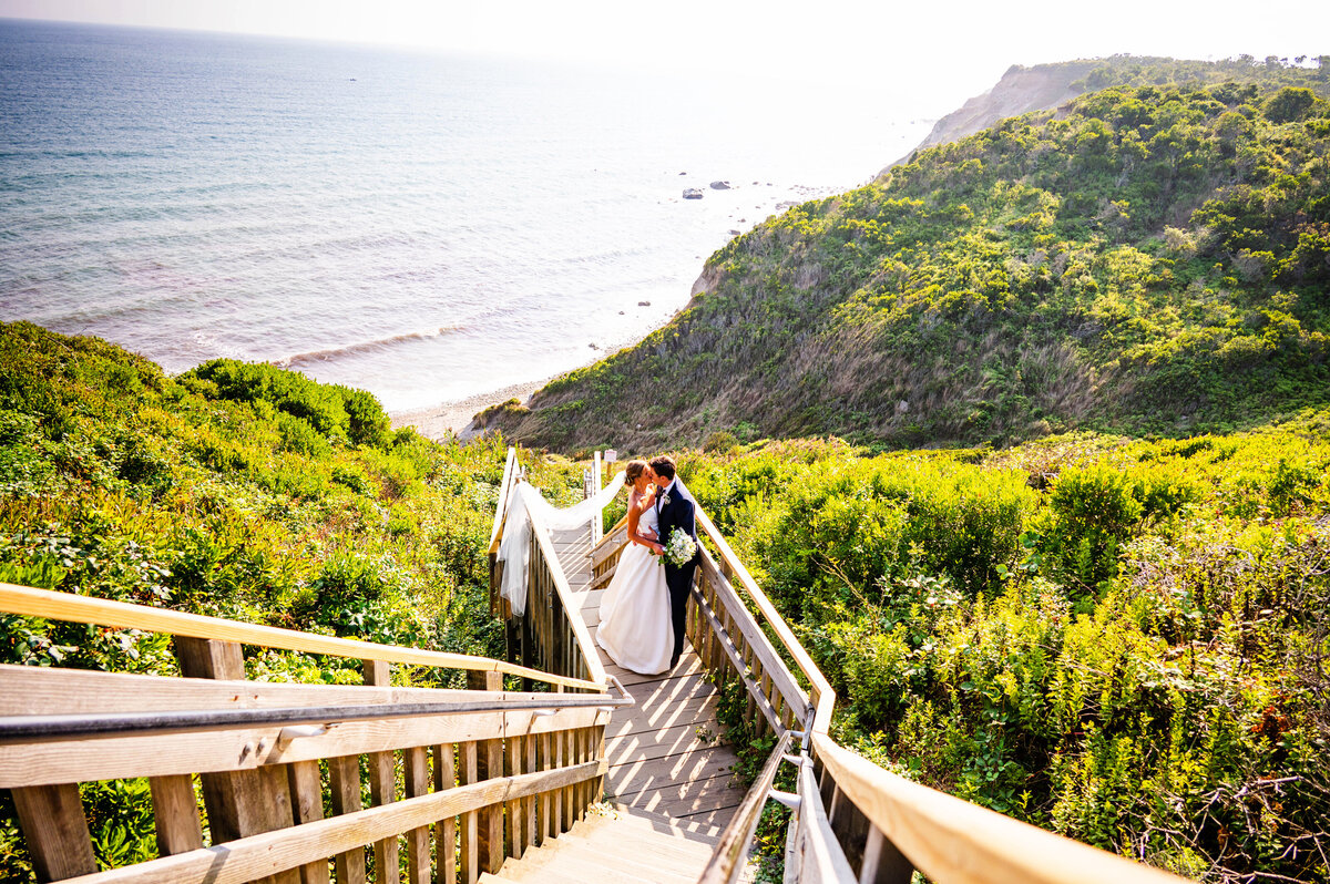 A wedding couple kiss on the Bluffs in Block Island.