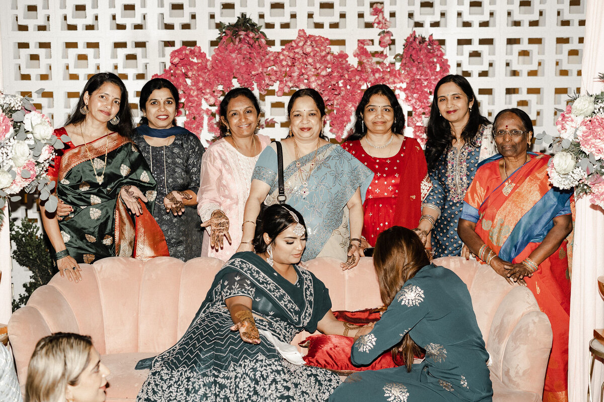 A group of woman dressed in traditional Indian garb gather in front of Hart and Main's Breezeblock wall  