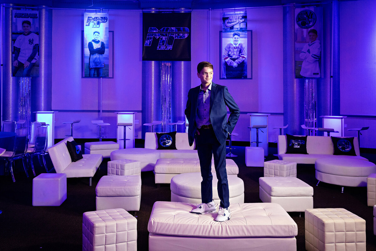 bar-mitzvah-boy-standing-couch-bnai-tikvah
