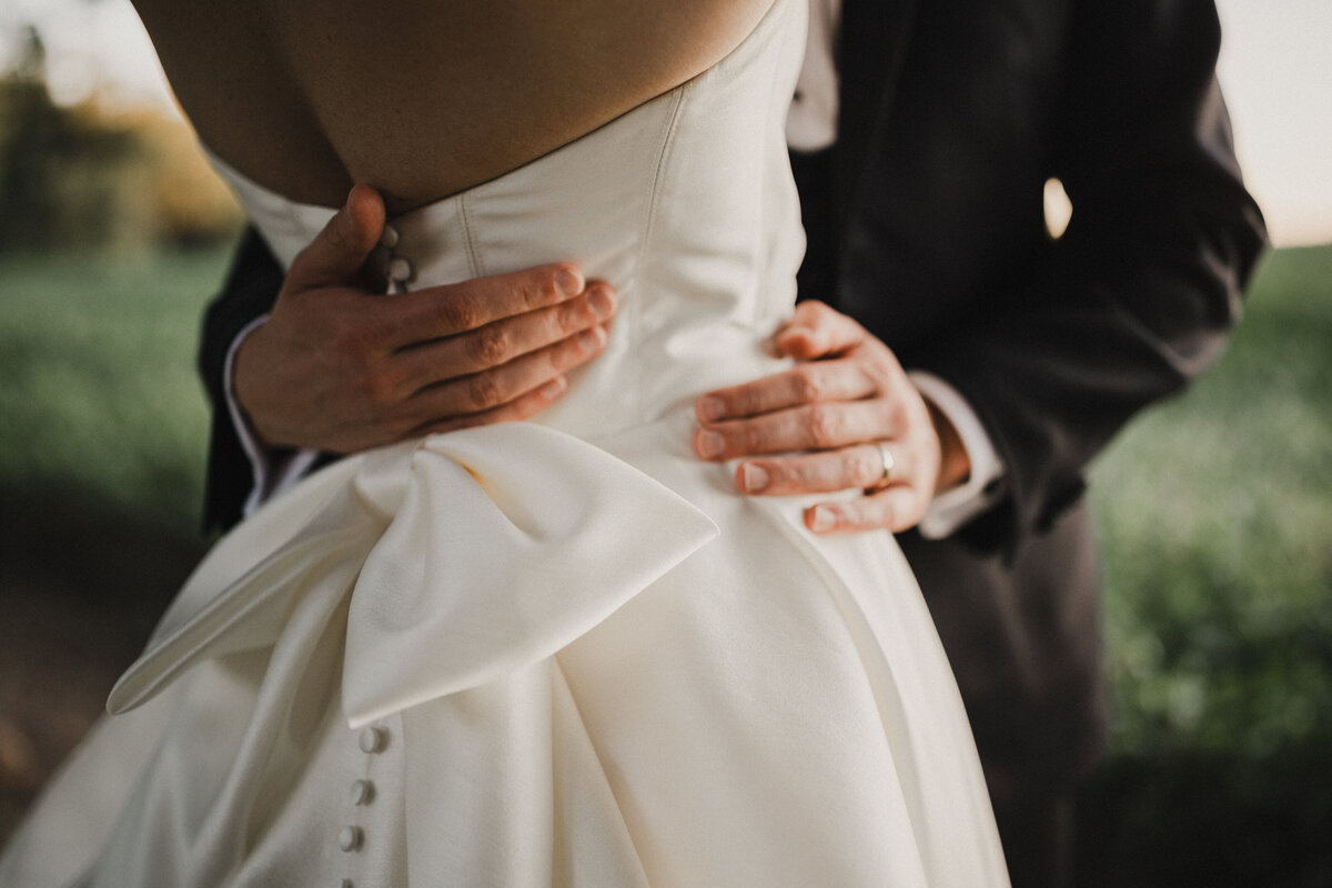 Groom holding the bride's waist