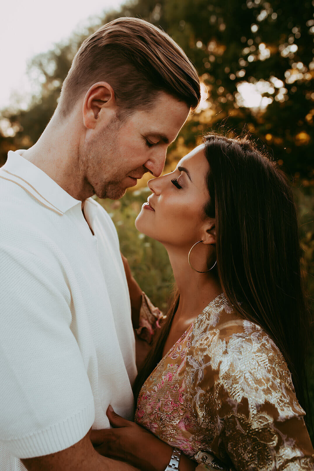a gorgeous couple embraced with their noses touching and eyes closed in rochester ny