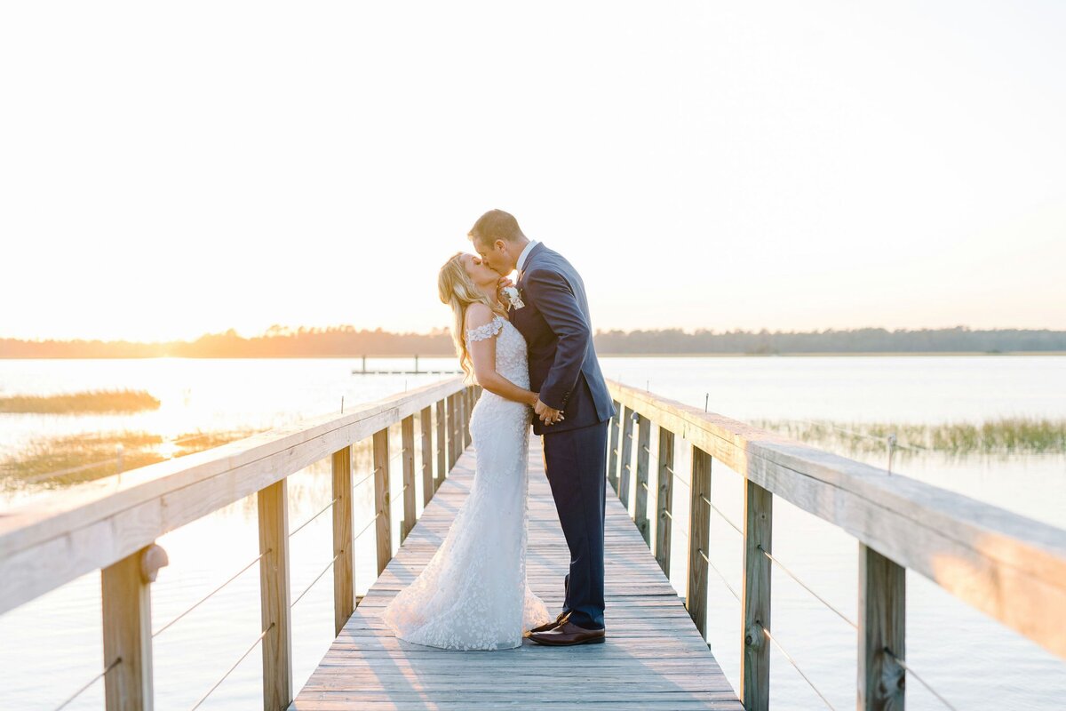 couple kissing on a dock