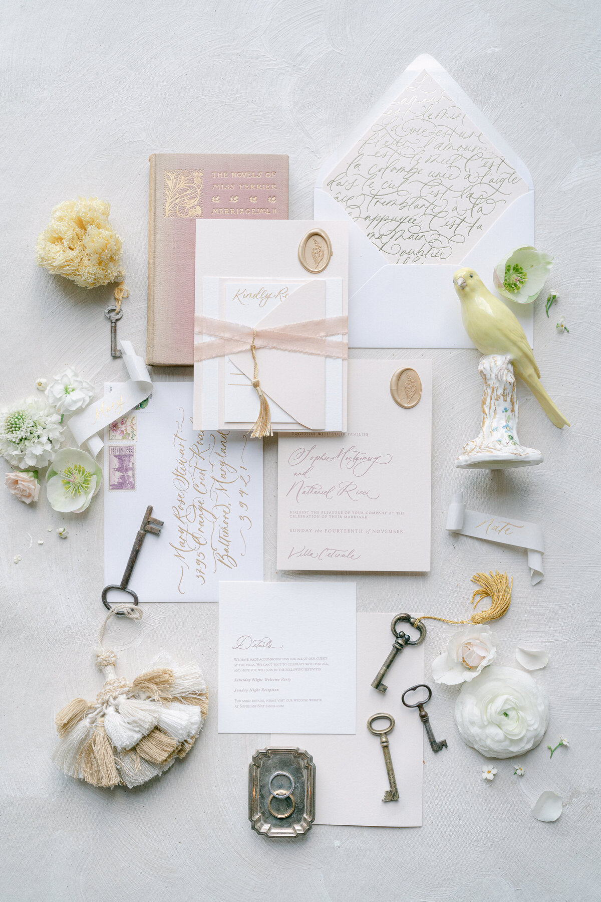 a wedding invitation suite with flowers and ribbons and old keys
