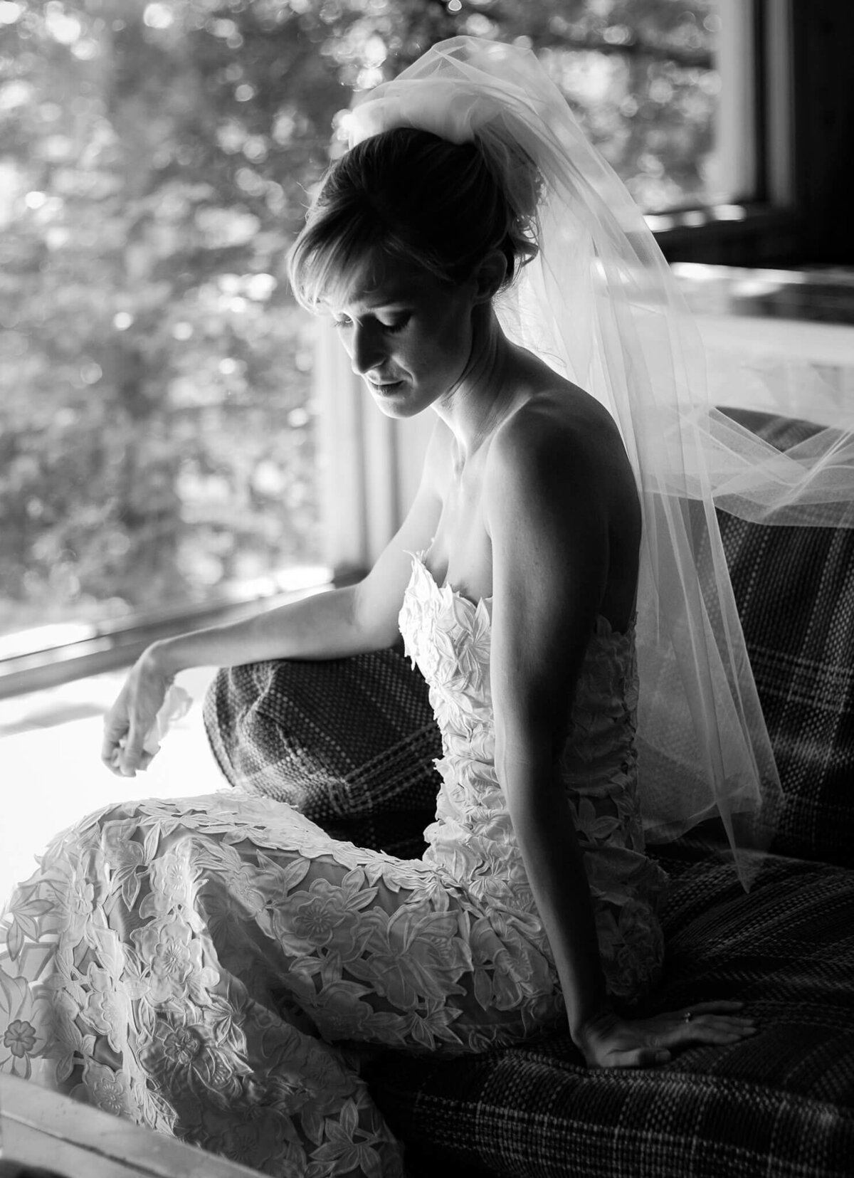Black and white of a bride  sitting calmly waiting to walk at ceremony