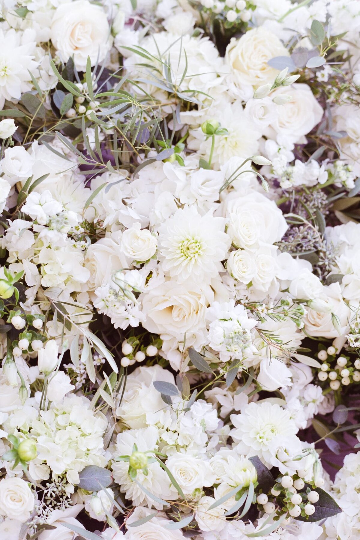 Floral arrangement of pretty white flowers for a courtyard wedding.