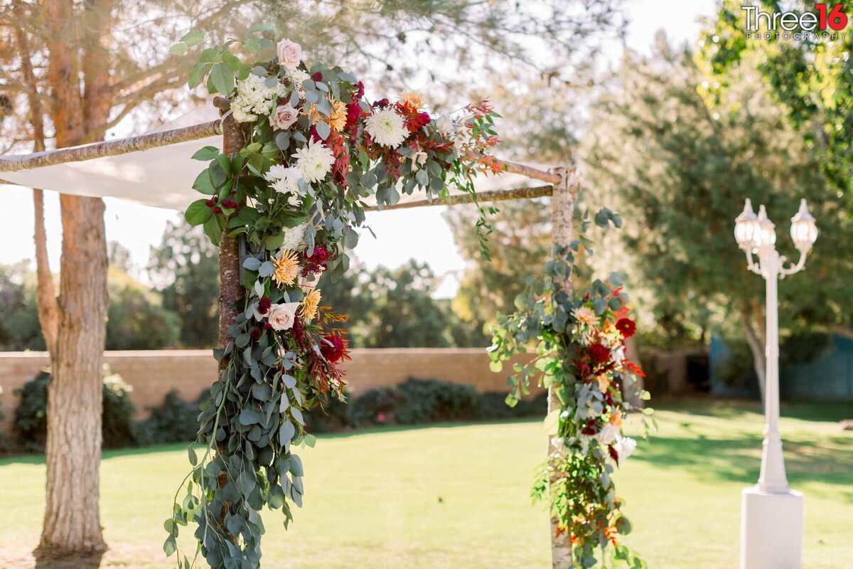 A Jewish traditional Chuppah is decorated with flowers
