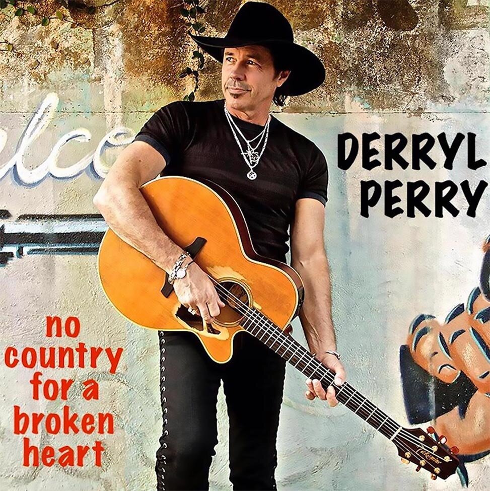 Single Cover Title No Country For A Broken Heart Artist Derrl Perry standing against weathered stone and graffiti wall wearing black tshirt black pants black cowboy hat and holding acoustic guitar