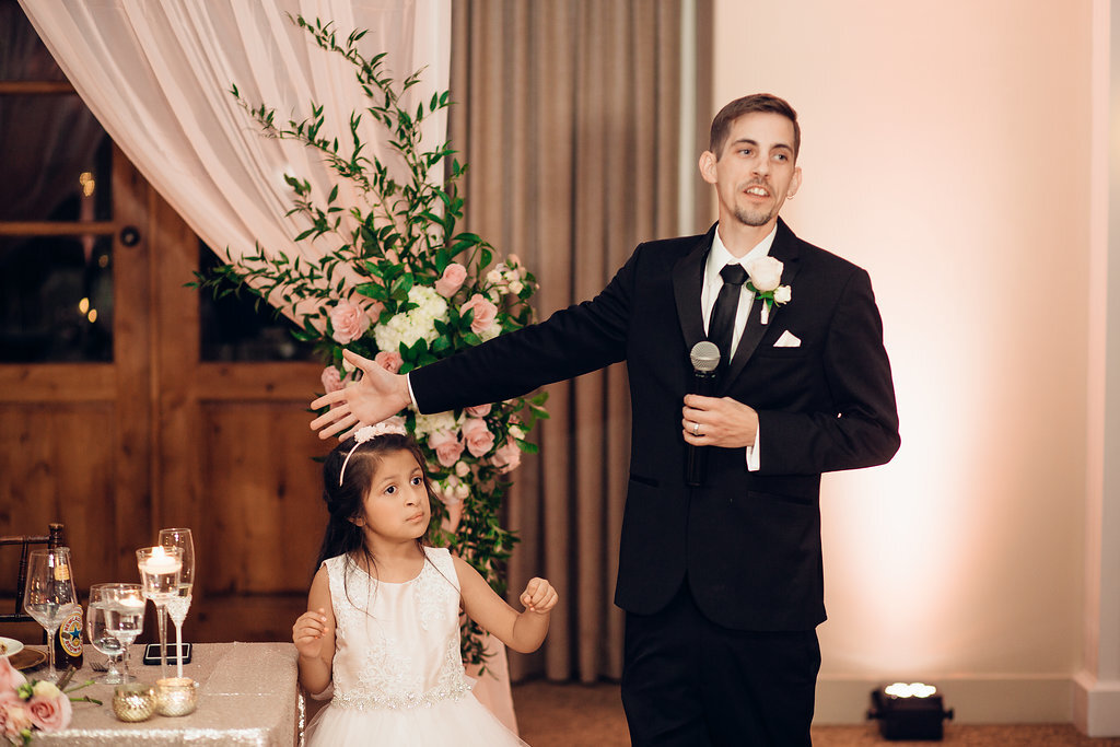 Wedding Photograph Of Groom Pointing To a Kid While Speaking In Microphone Los Angeles