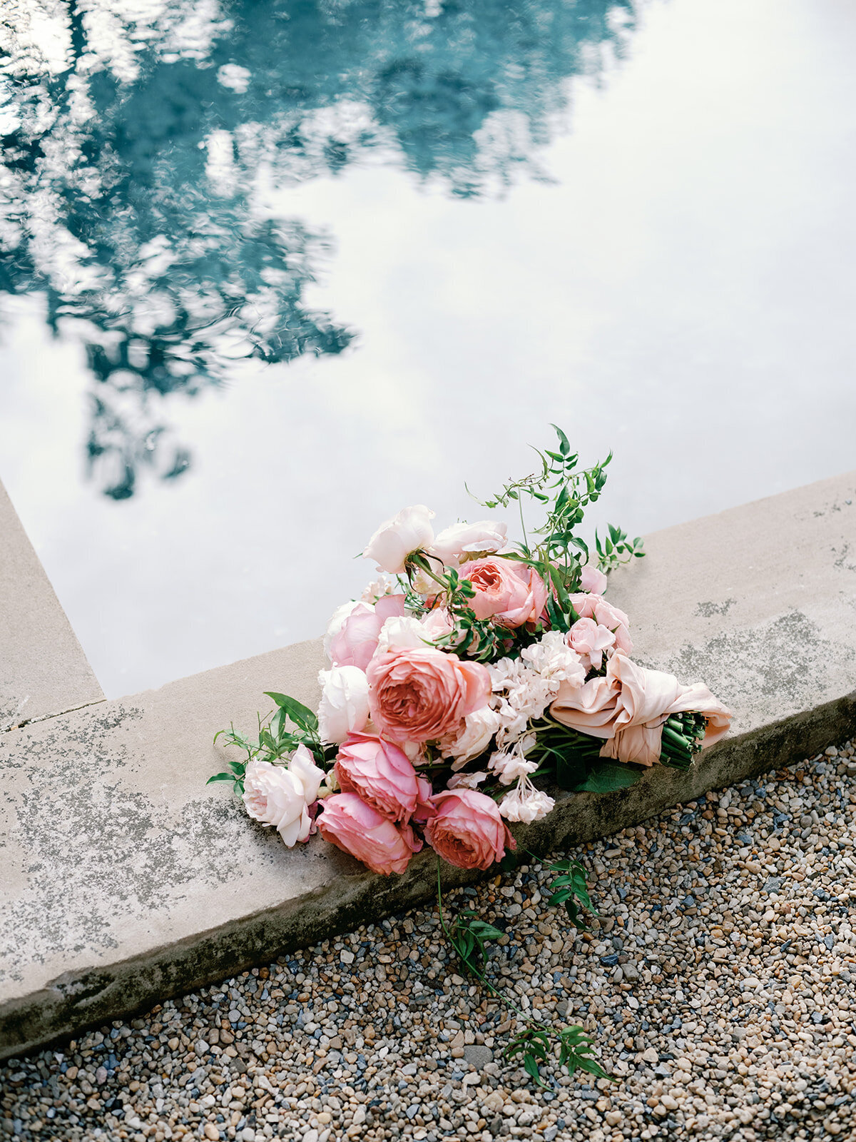 Pink and blush floral bouquet sitting by the poolside at Larz Anderson House