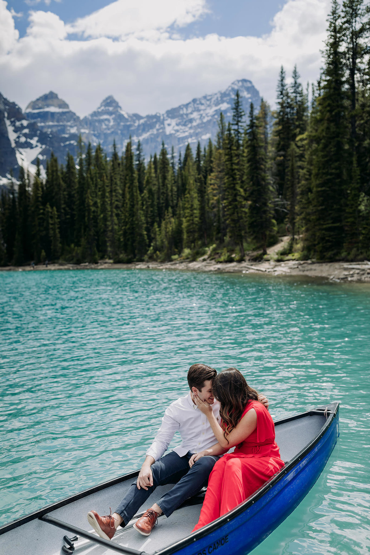 formal engagement photos at moraine lake in blue canoe