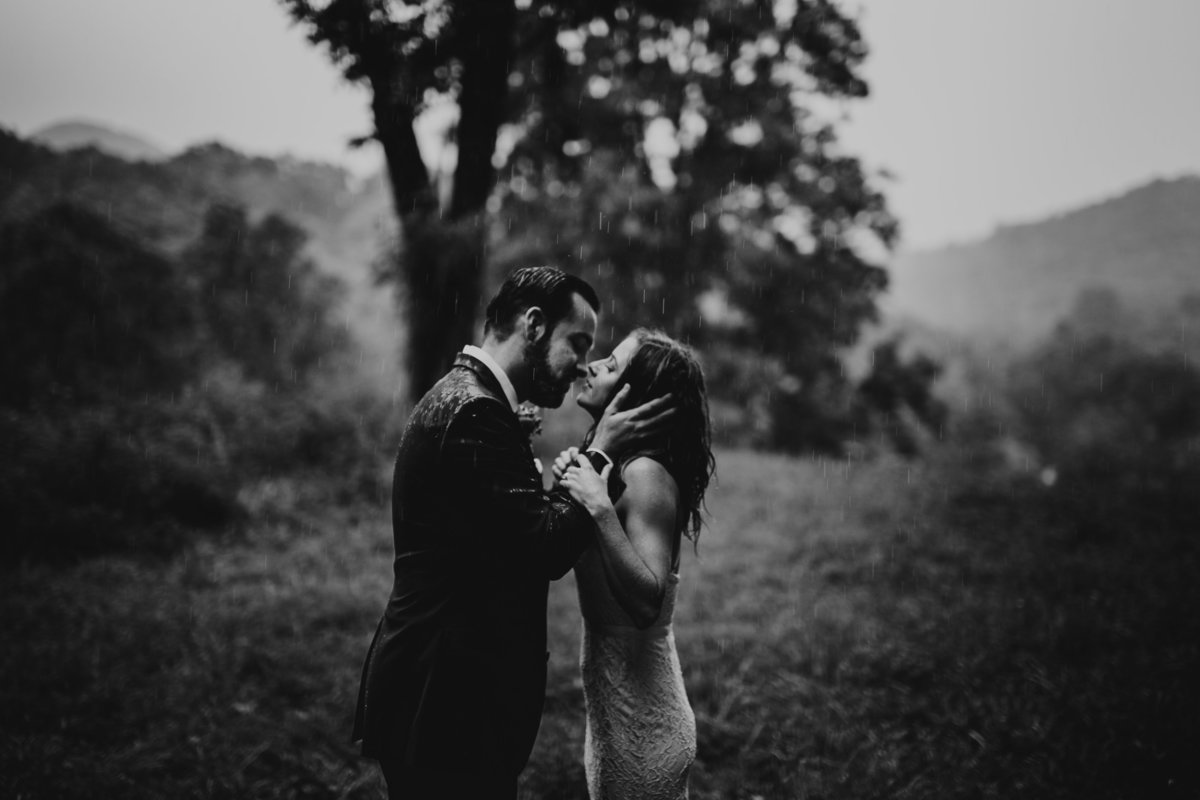 Couple sealing their vows with a kiss during their elopement in a rain storm