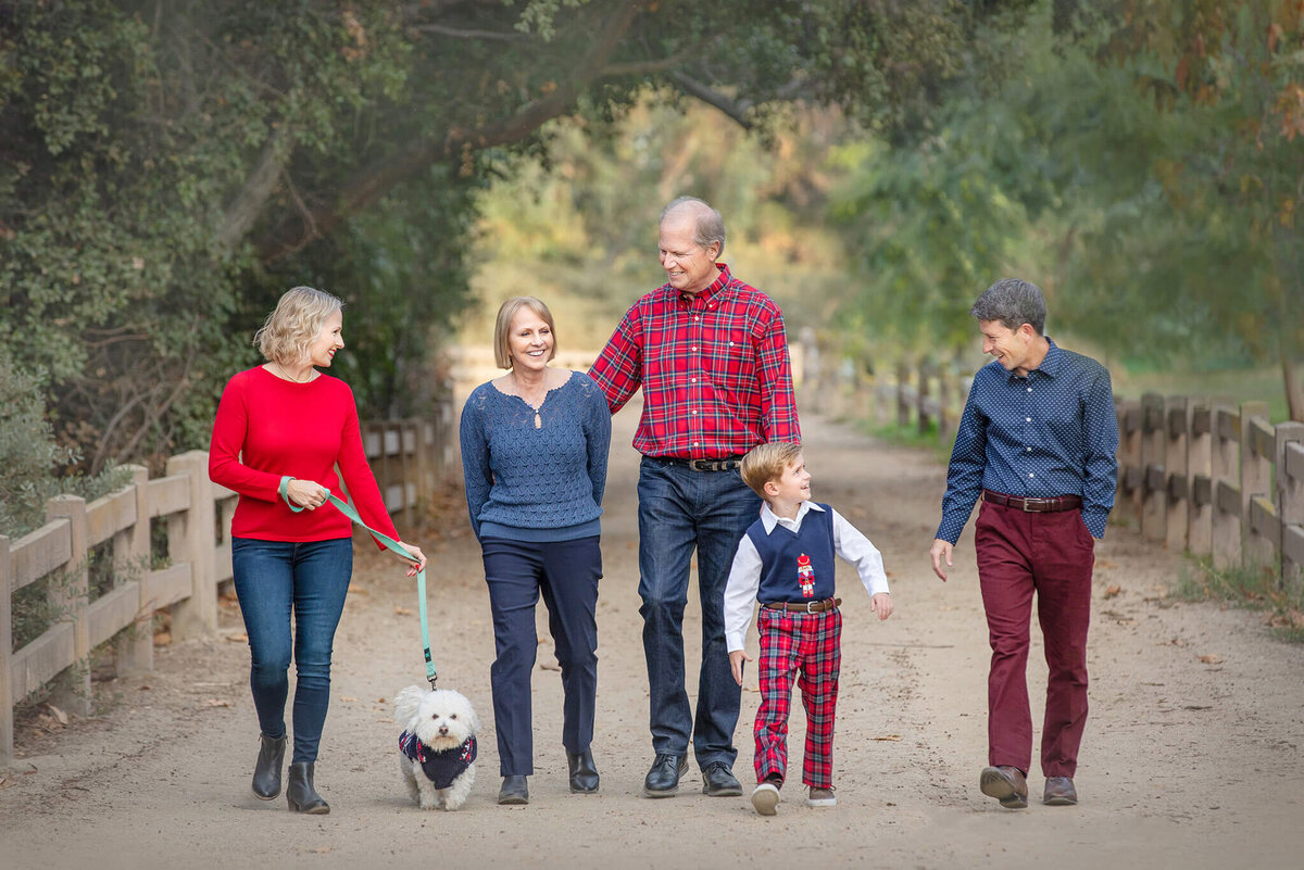 Mom, dad, son, grandparents and dog photographed lauging and walking along in Griffith Park at Christmas