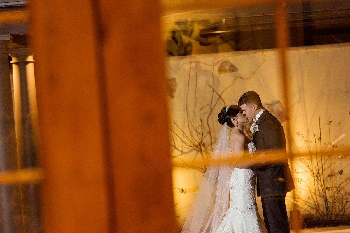 Bride and groom kissing outside Larkfield Manor