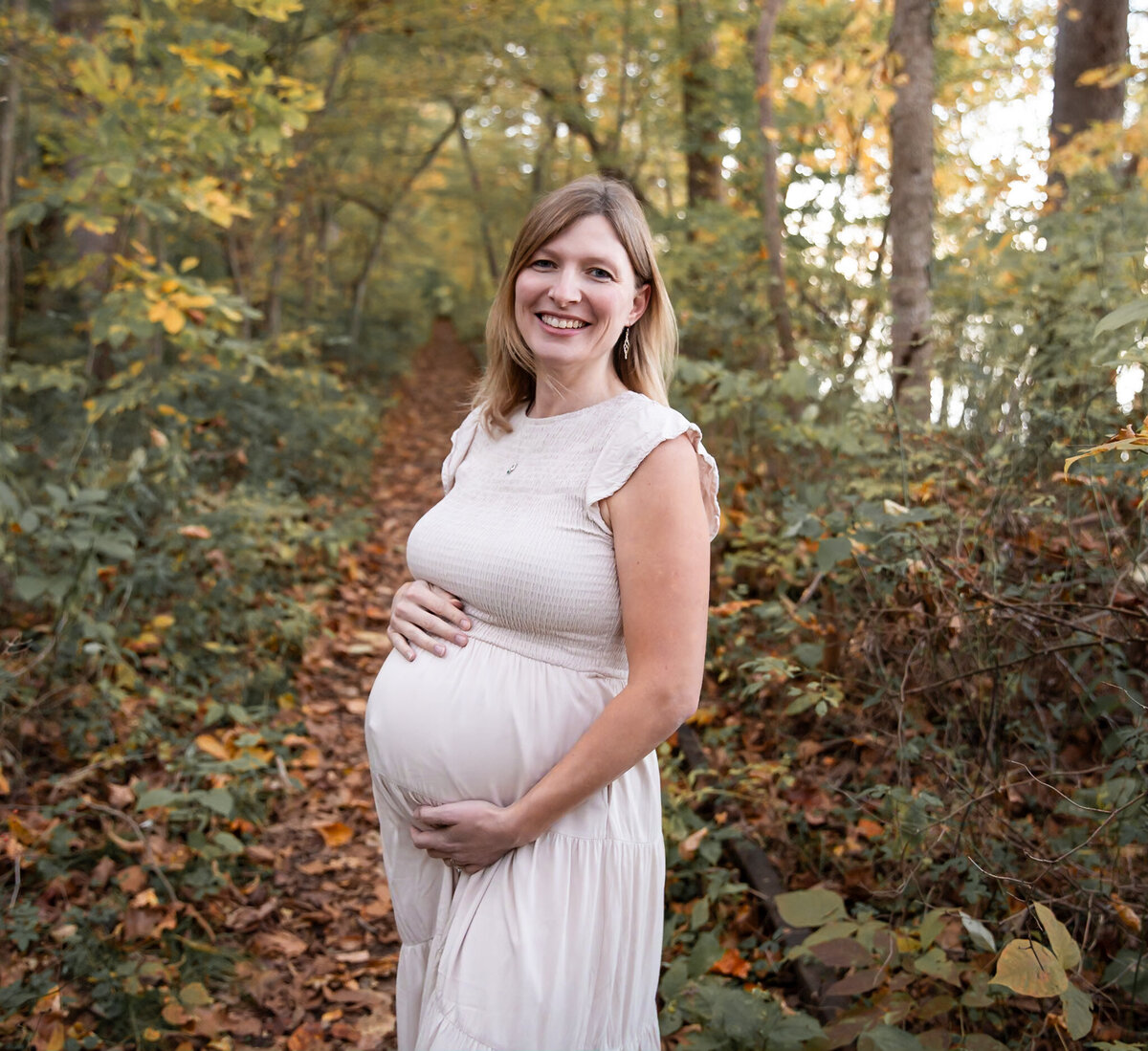 Pregnant mother smiles during her photo session in Harford County, Maryland