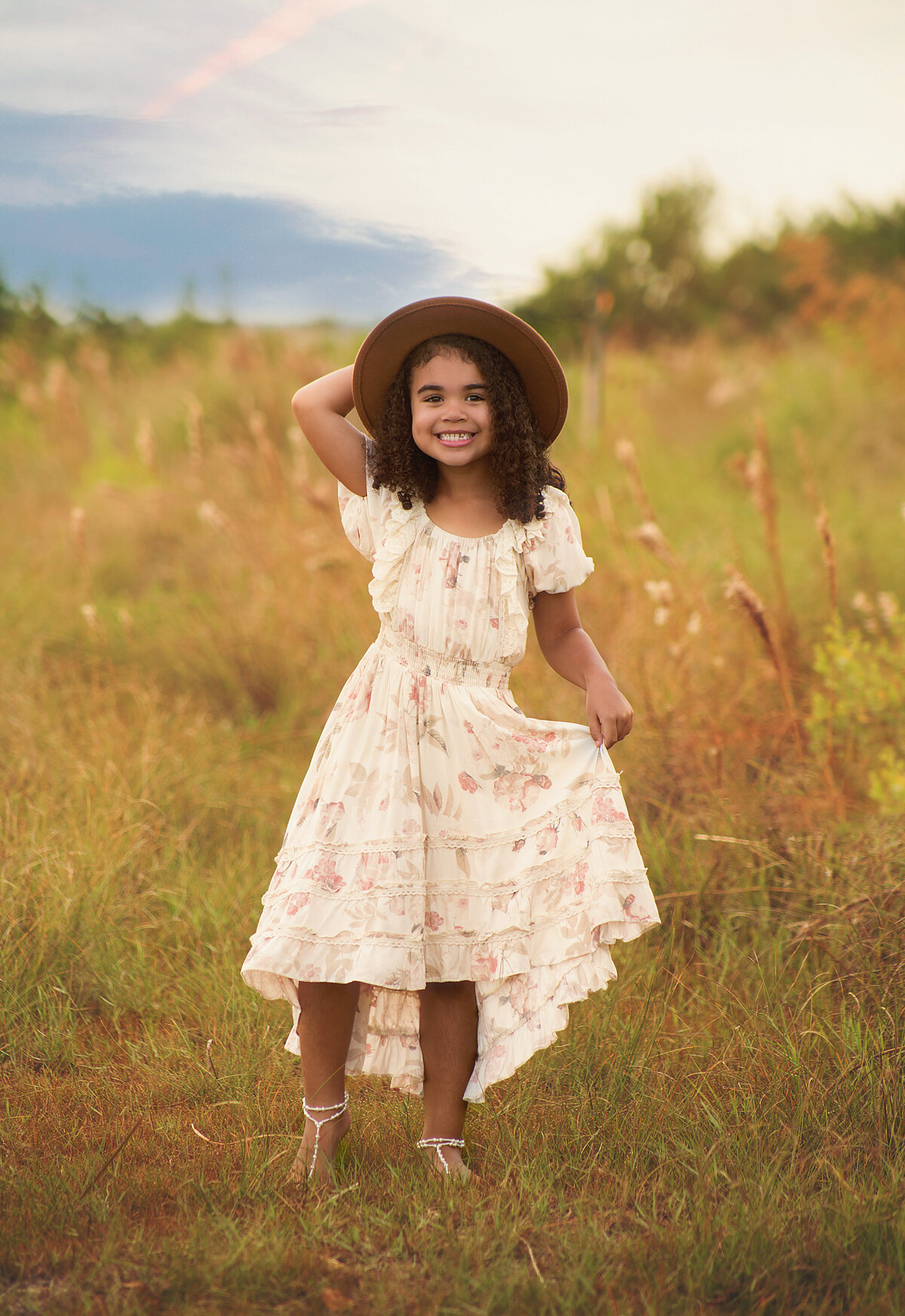Little girl wearing flowy dress and hat during family photoshoot in Mount Juliet tennessee