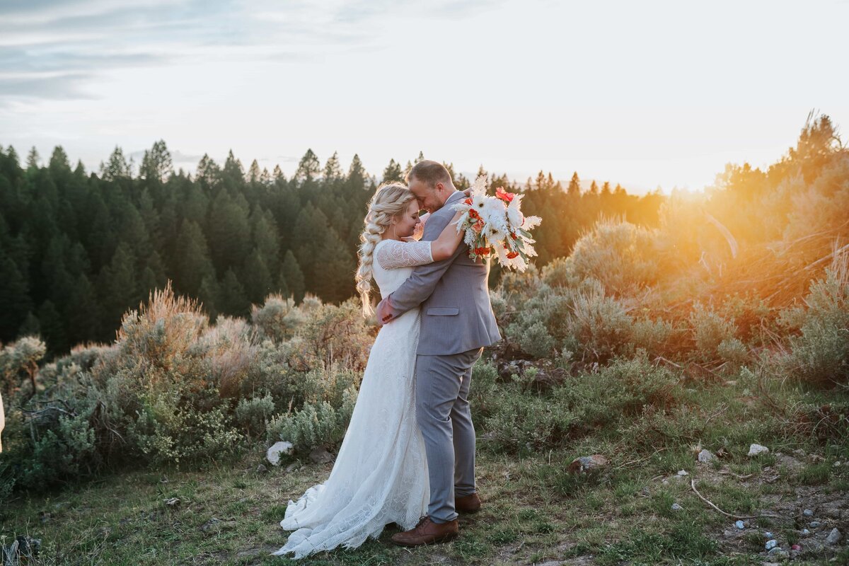 Lake Tahoe wedding photographer captures bride hugging groom during forest bridals