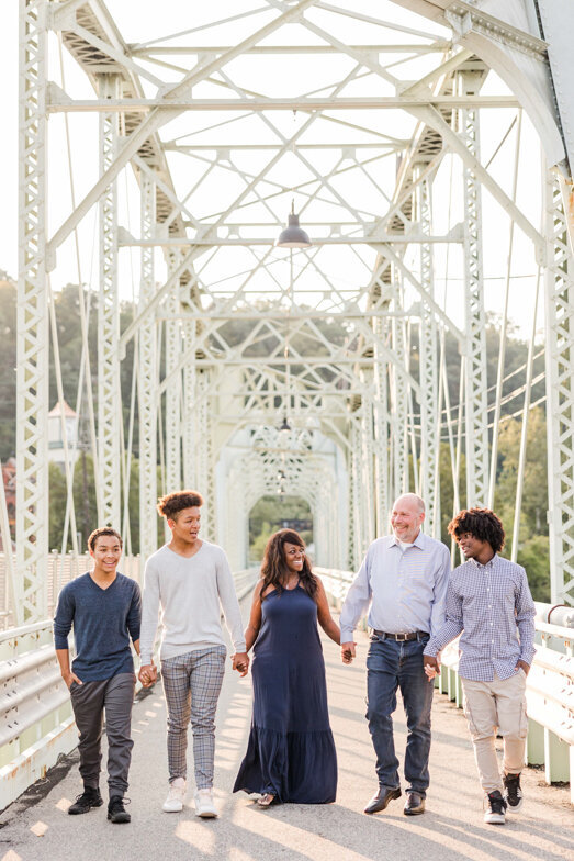 family of five walking on bridge