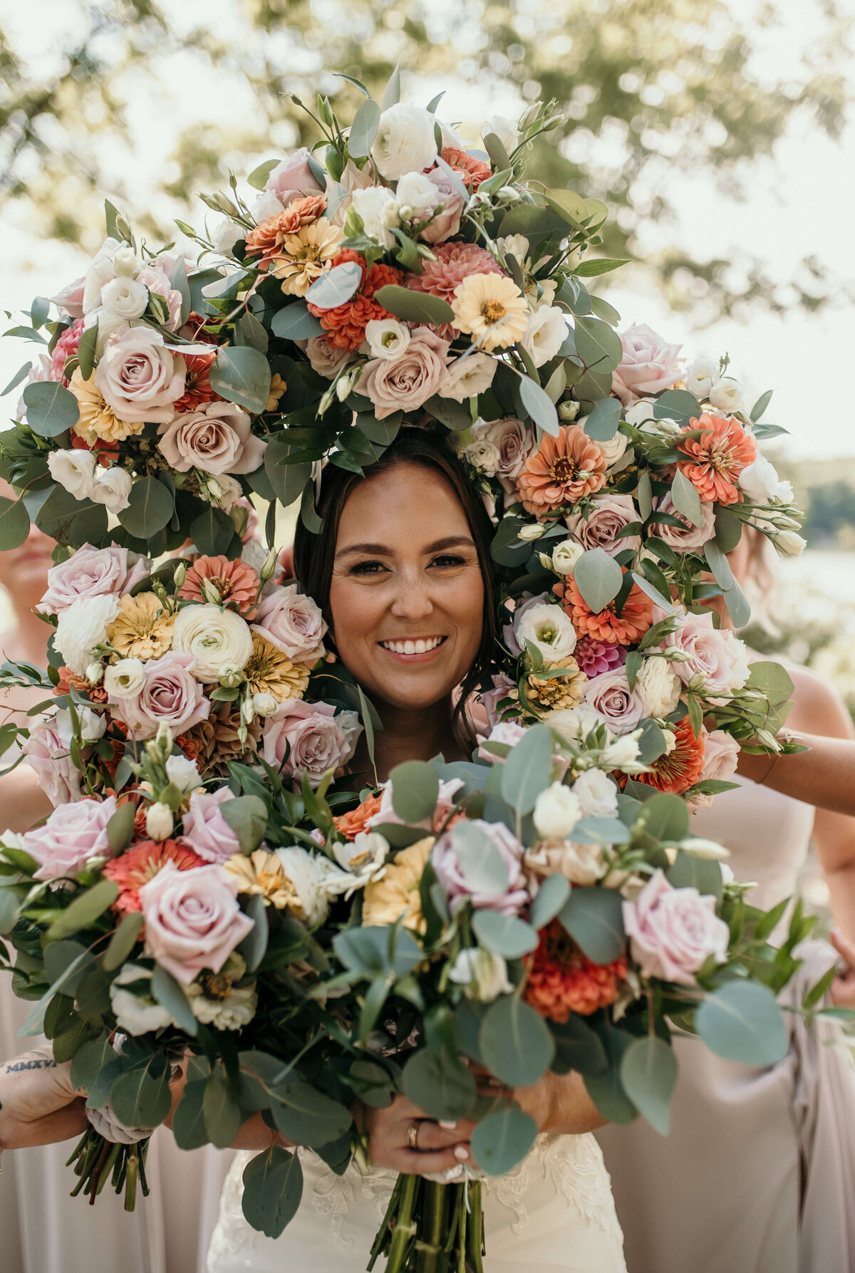 Bride smiles with flowers around her face