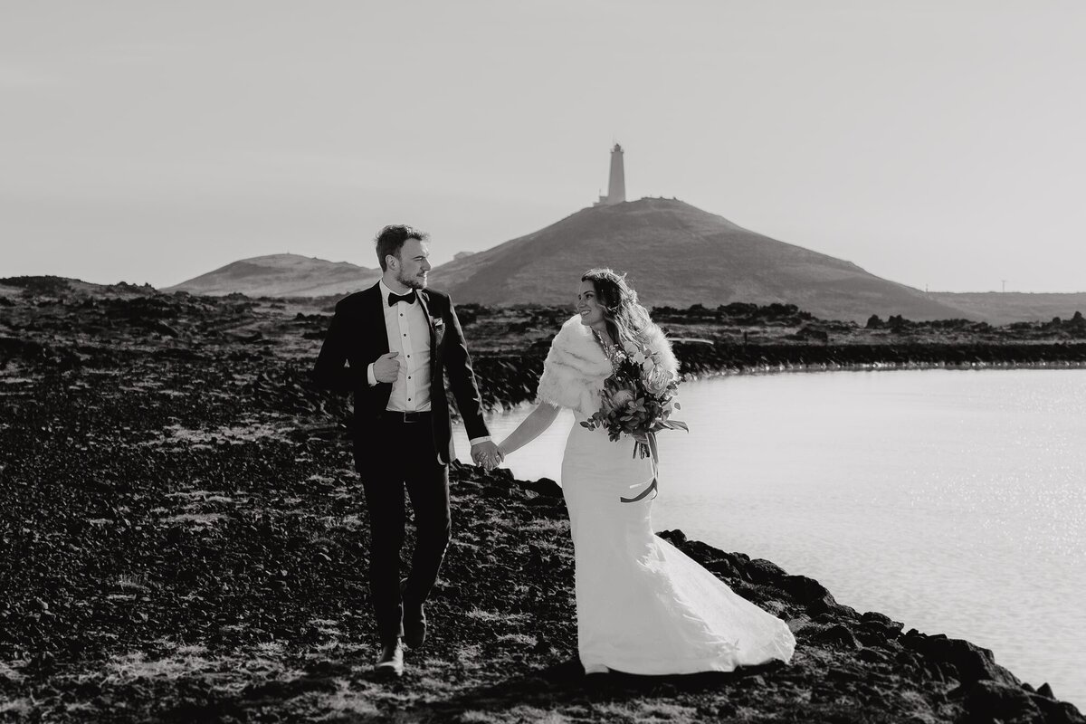 In timeless black and white, the couple's portrait at the Blue Lagoon captures the essence of their love, with the iconic lighthouse standing as a silent witness to their beautiful story.